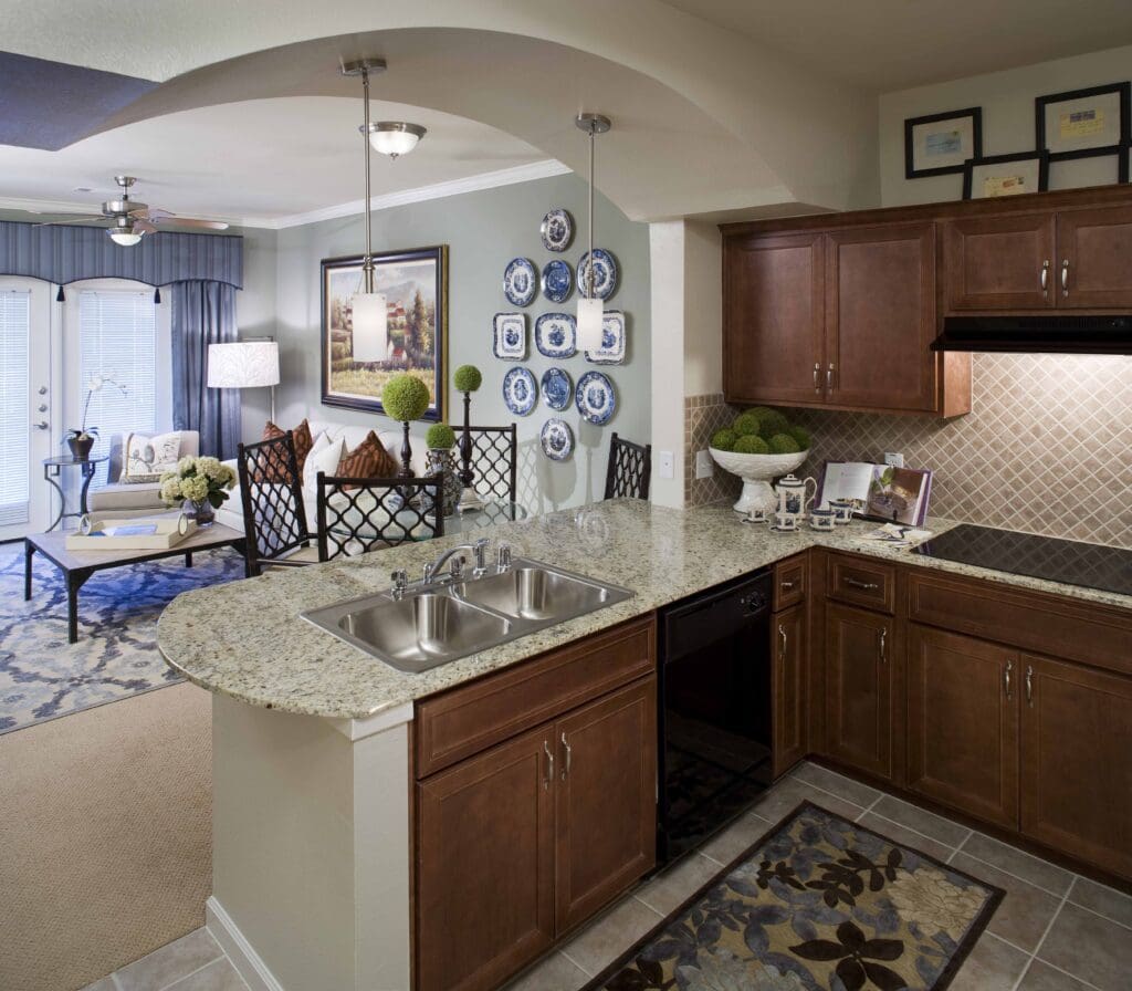 Interior image of a resident's kitchen, dining, and living room at Lake Highlands, an independent living community near Rockwall, TX.