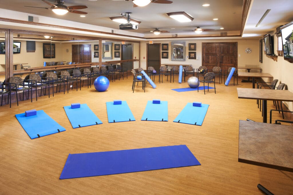 Multipurpose-room - The Landon at Lake Highlands Interior image of a gym space set up for a yoga class at The Landon at Lake Highlands, a senior living community in Lakewood, TX.