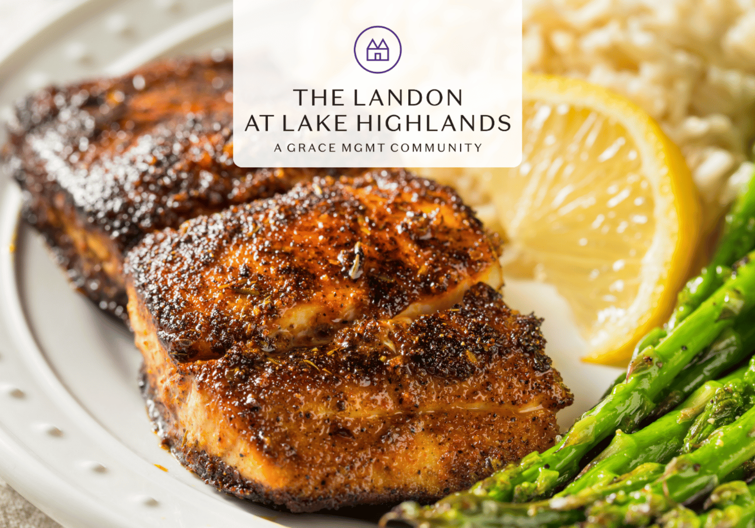 Plate of roasted, seasoned chicken with lemon slice and asparagus, with The Landon at Lake Highlands branding overlay (logo at center).