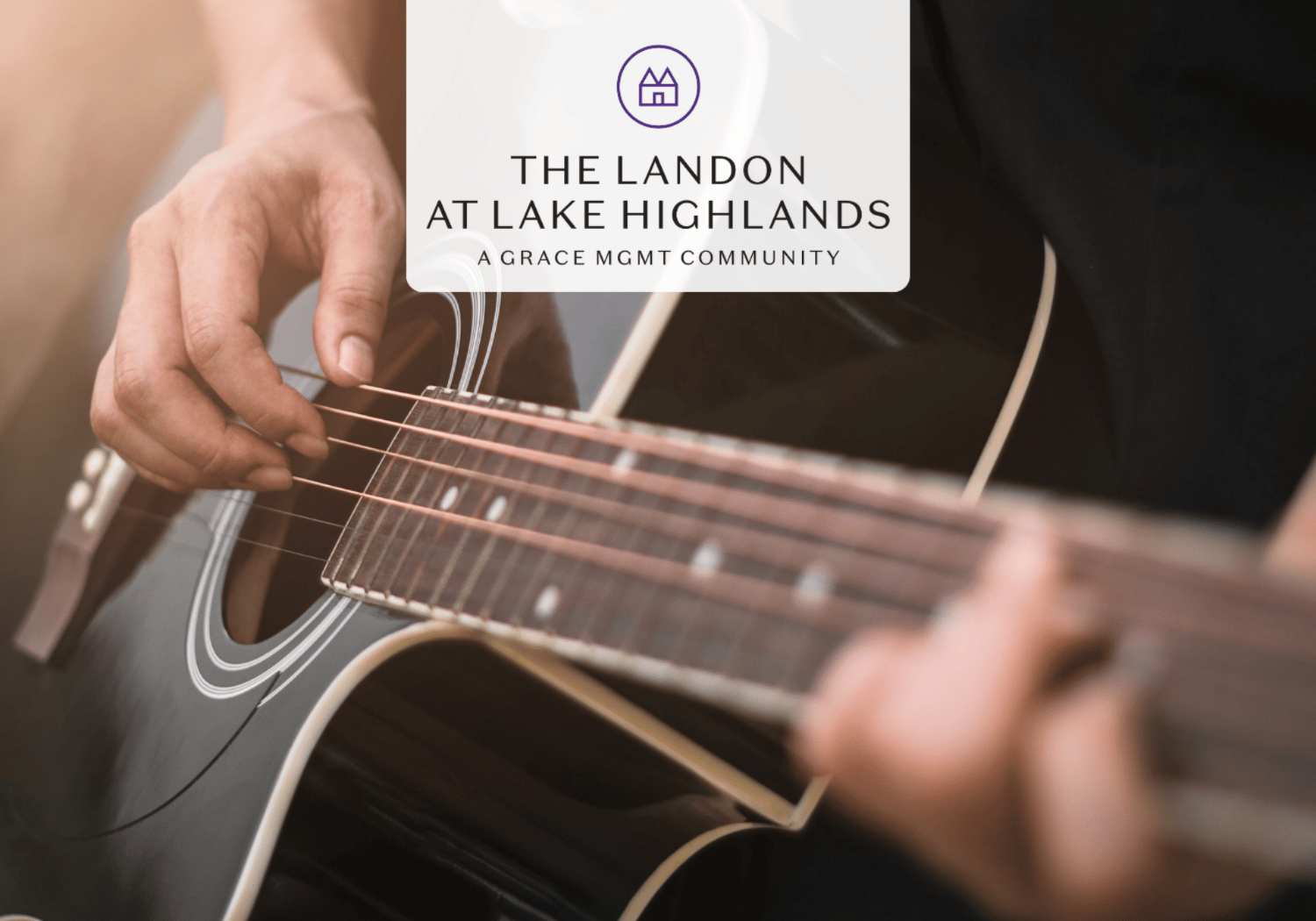 Close-up of a person playing an acoustic guitar with a white rounded logo overlay reading 'The Landon at Lake Highlands'